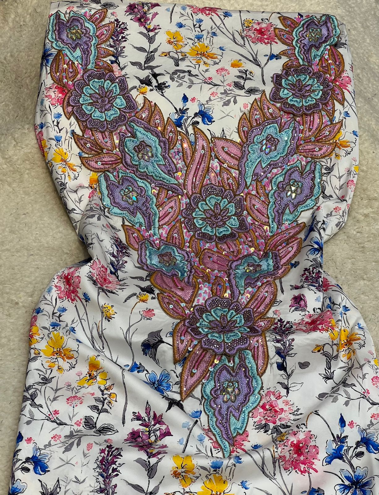This authentic Italian silk fabric features intricate 3D embroidery with crystals and hand-beaded details