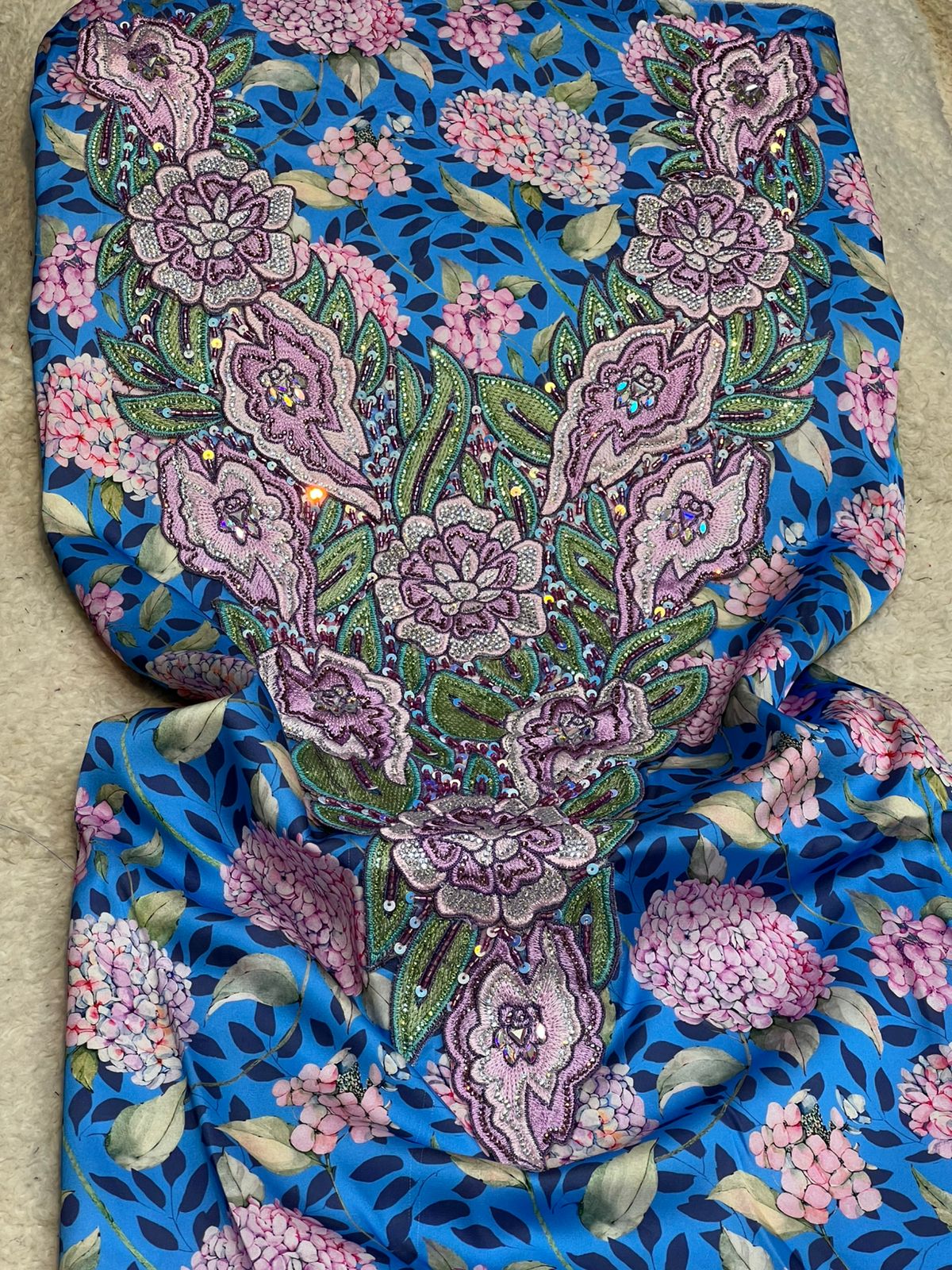 This authentic Italian silk fabric features intricate 3D embroidery with crystals and hand-beaded details