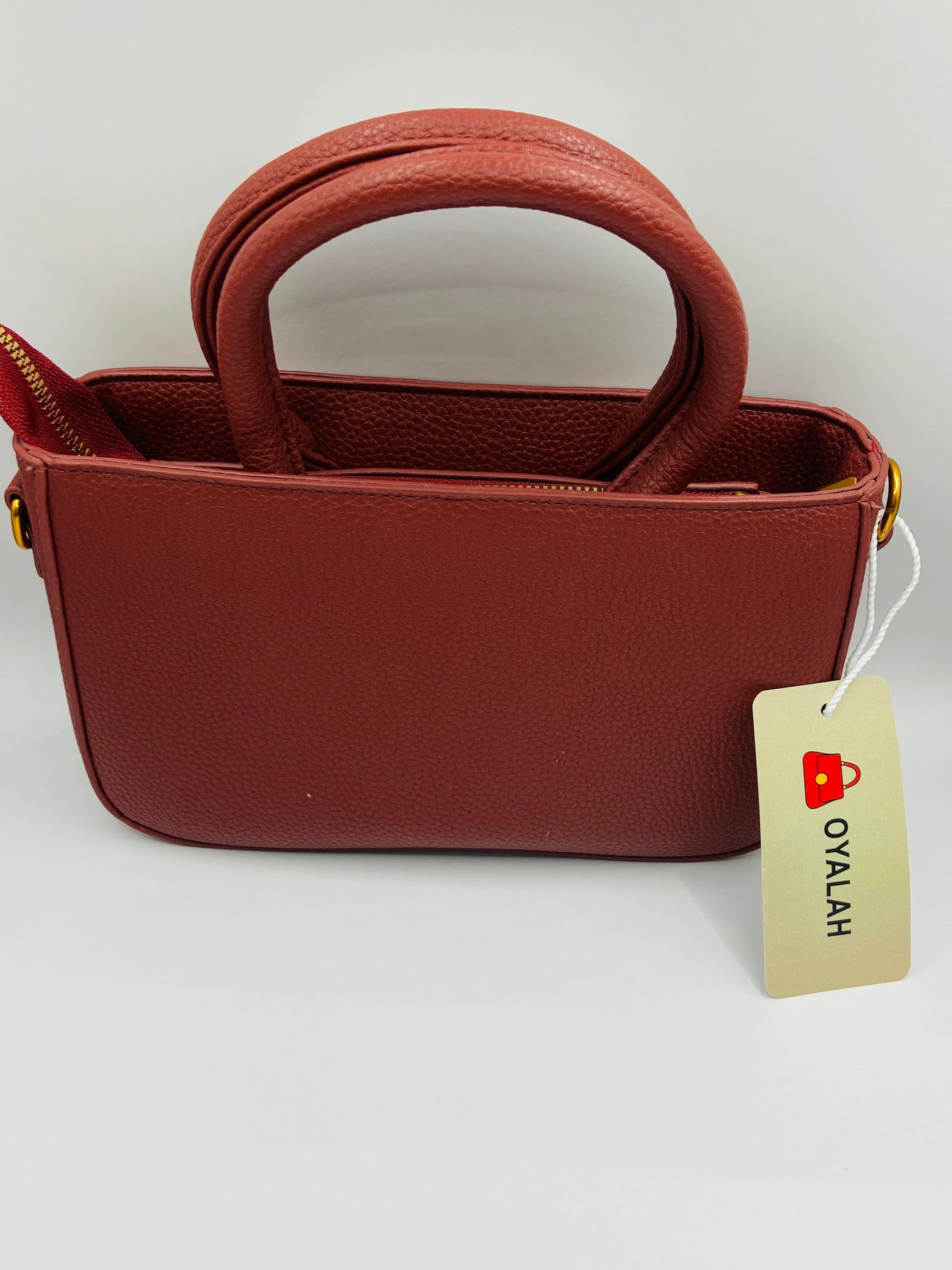 This handbag is a structured, genuine leather tote-style bag designed for modern women who value both elegance and functionality.