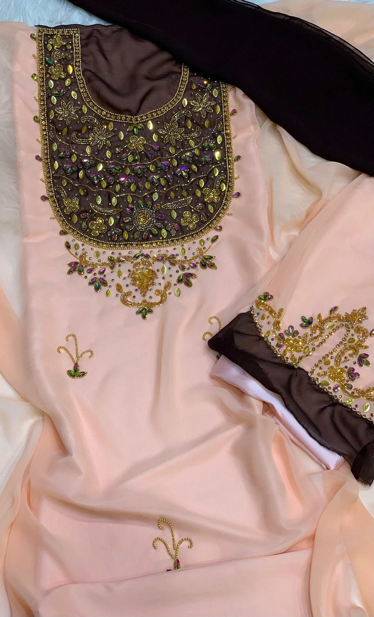 This elegant piece features chiffon with luxurious hand-beaded embroidery, and is lined with Armani silk for ultimate comfort and elegance
