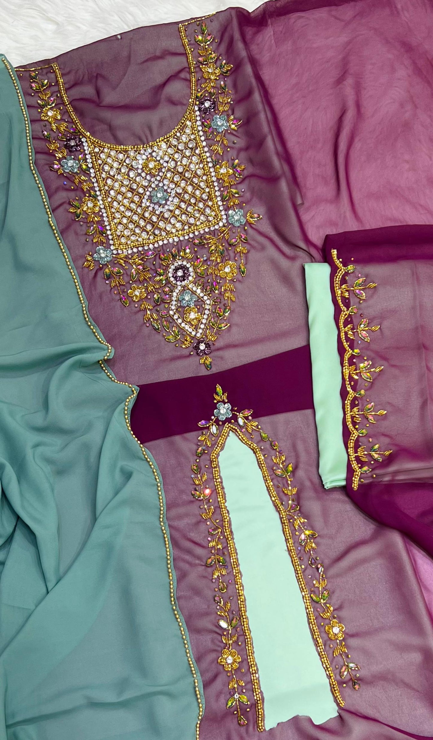 A luxurious abaya crafted from soft chiffon, embellished with delicate beaded embroidery extending down the bodice