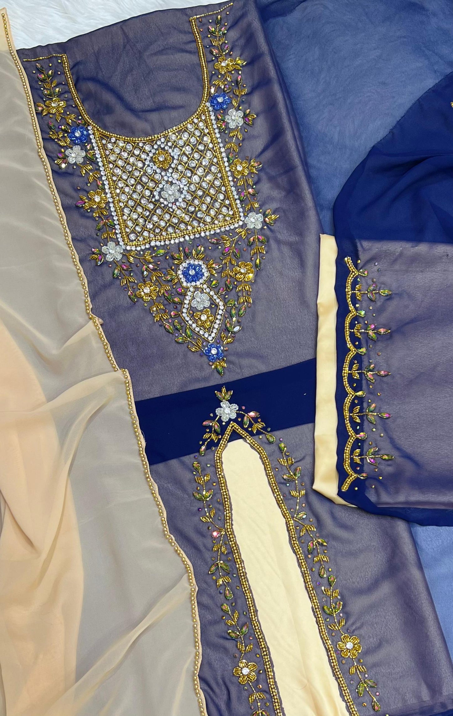 A luxurious abaya crafted from soft chiffon, embellished with delicate beaded embroidery extending down the bodice
