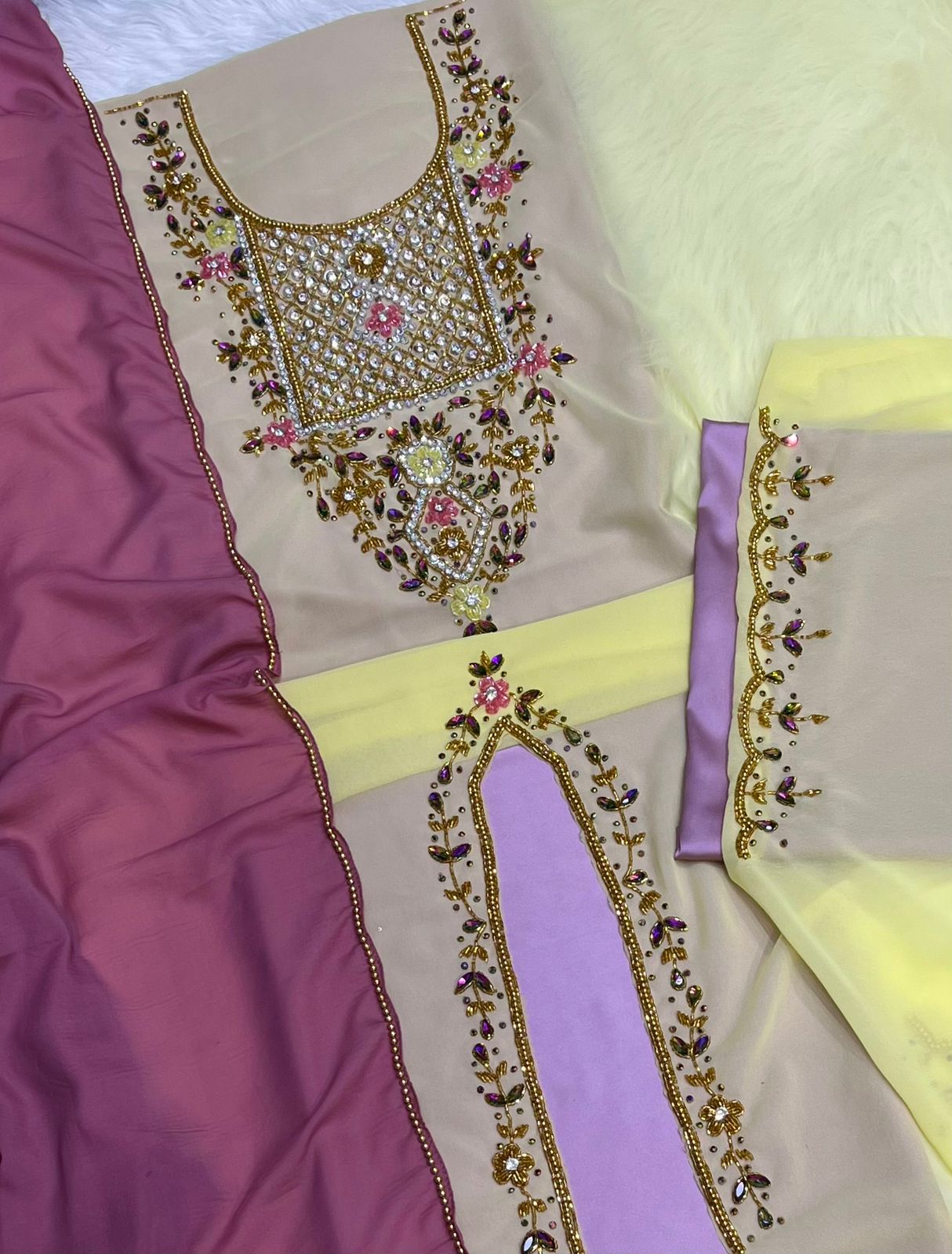 A luxurious abaya crafted from soft chiffon, embellished with delicate beaded embroidery extending down the bodice