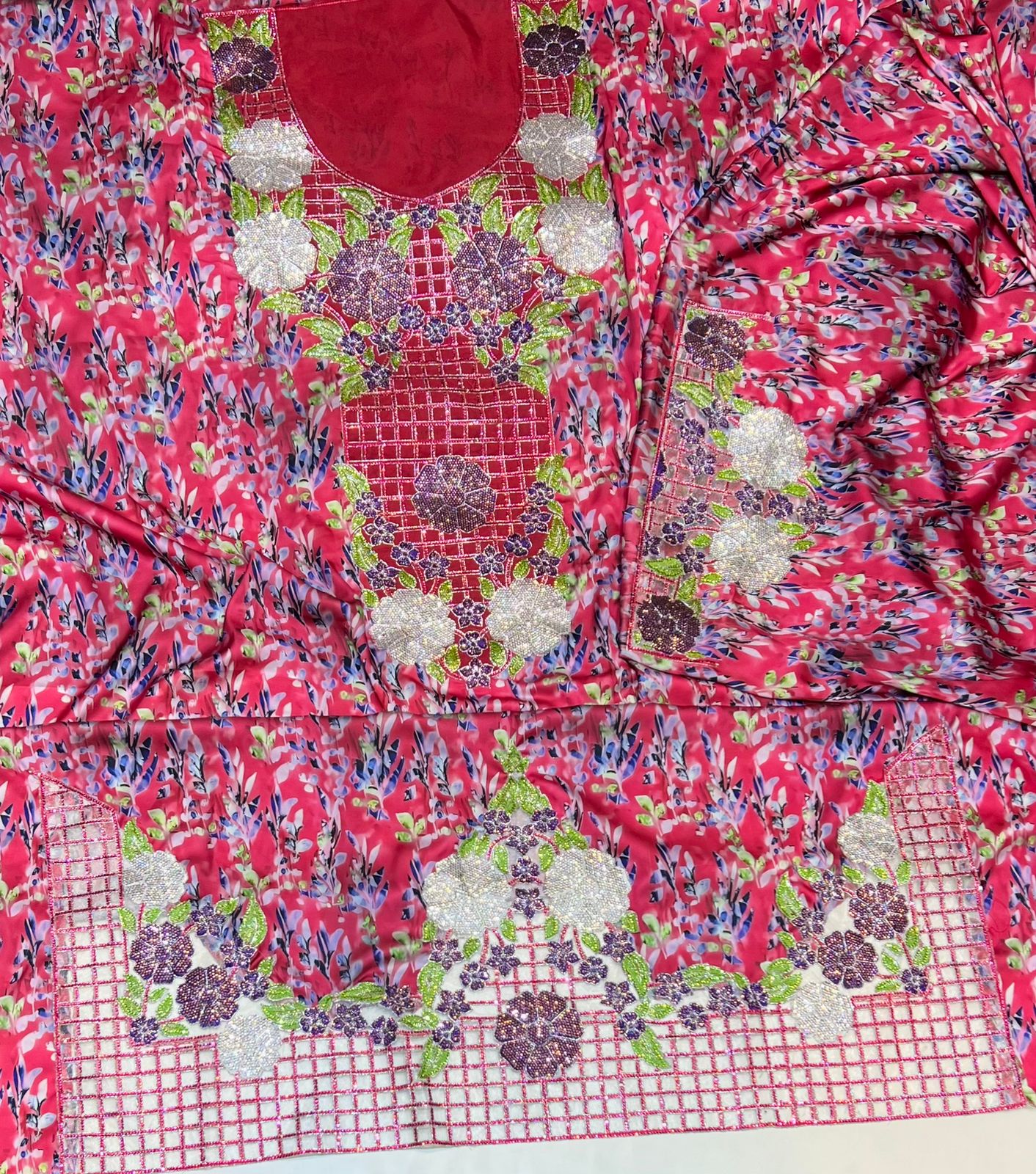 Italian raw silk fabric embellished with intricate embroidery featuring 6-pointed stones and an elegant hemline