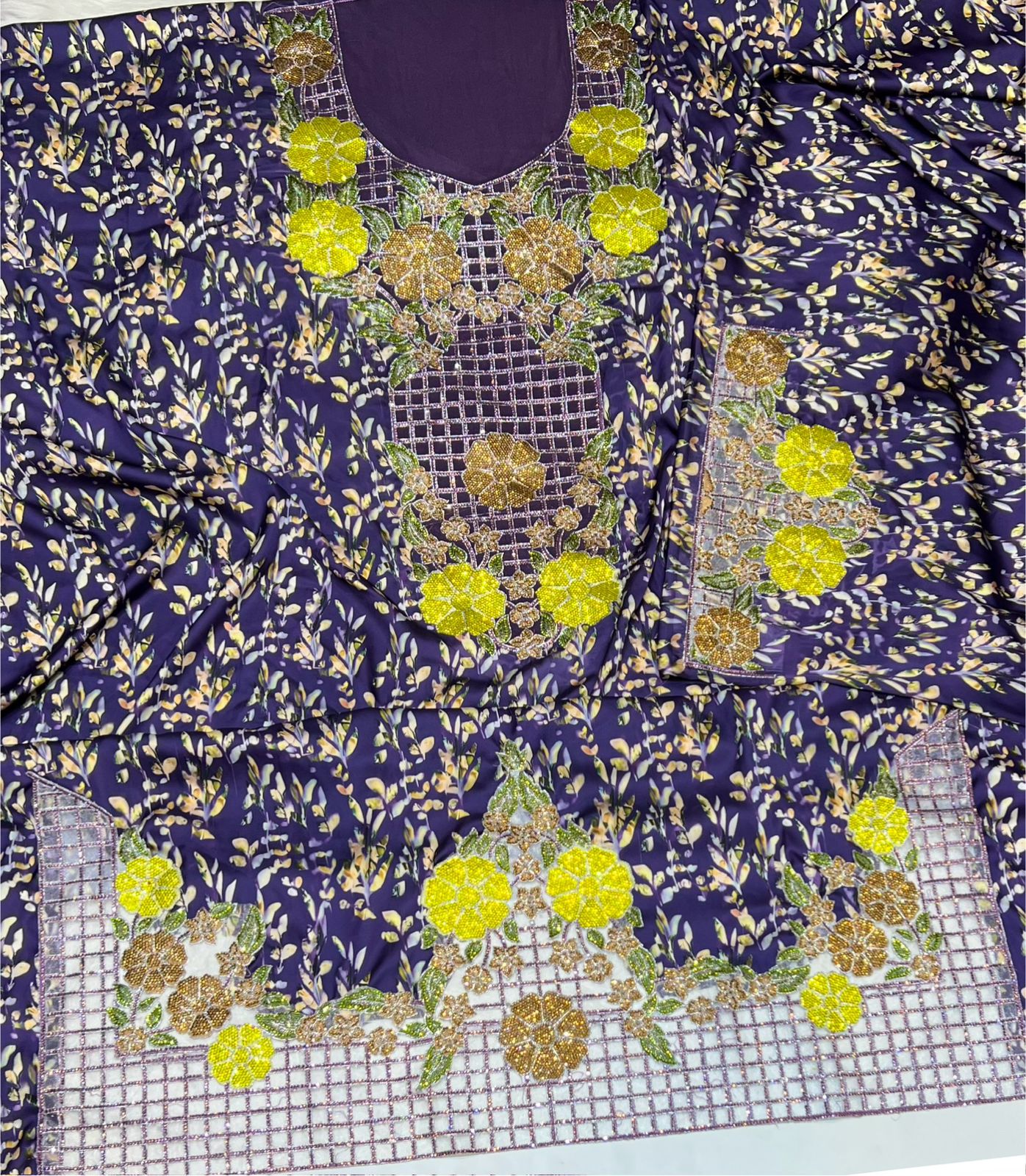 Italian raw silk fabric embellished with intricate embroidery featuring 6-pointed stones and an elegant hemline