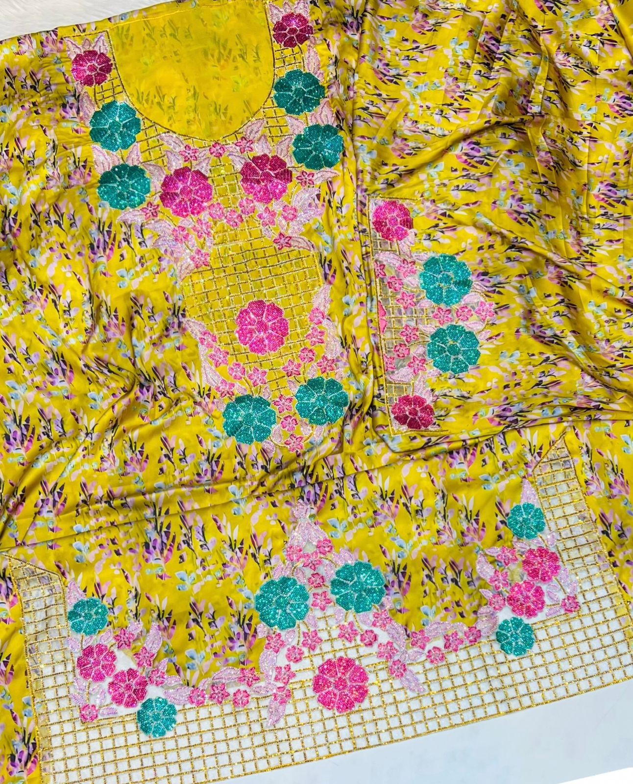 Italian raw silk fabric embellished with intricate embroidery featuring 6-pointed stones and an elegant hemline