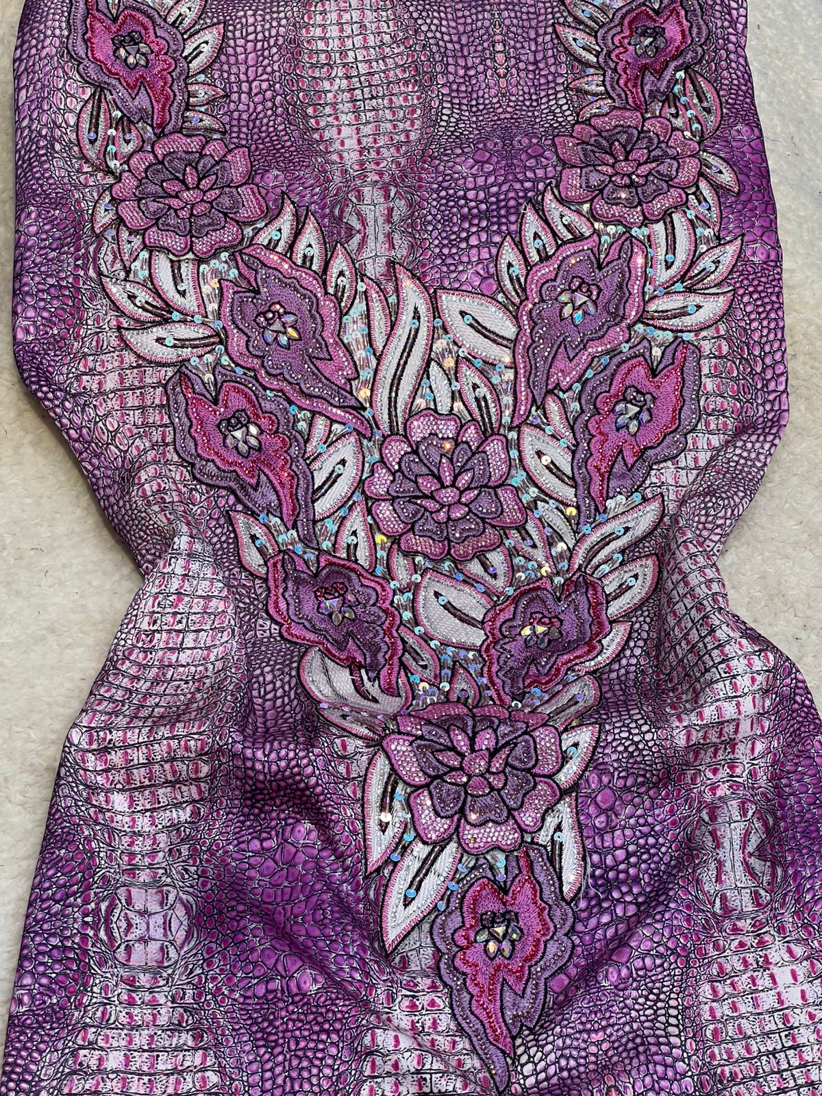 This authentic Italian silk fabric features intricate 3D embroidery with crystals and hand-beaded details