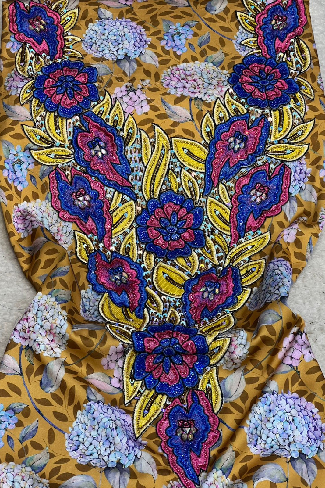 This authentic Italian silk fabric features intricate 3D embroidery with crystals and hand-beaded details