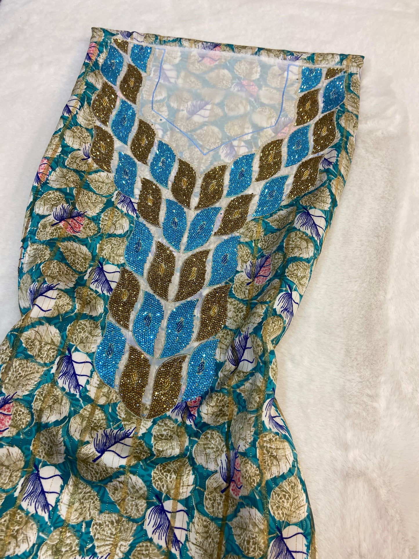 This luxurious Indonesian silk is presented in a new design, adorned with delicately set stones and six beads