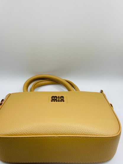 This handbag is a structured, genuine leather tote-style bag designed for modern women who value both elegance and functionality.