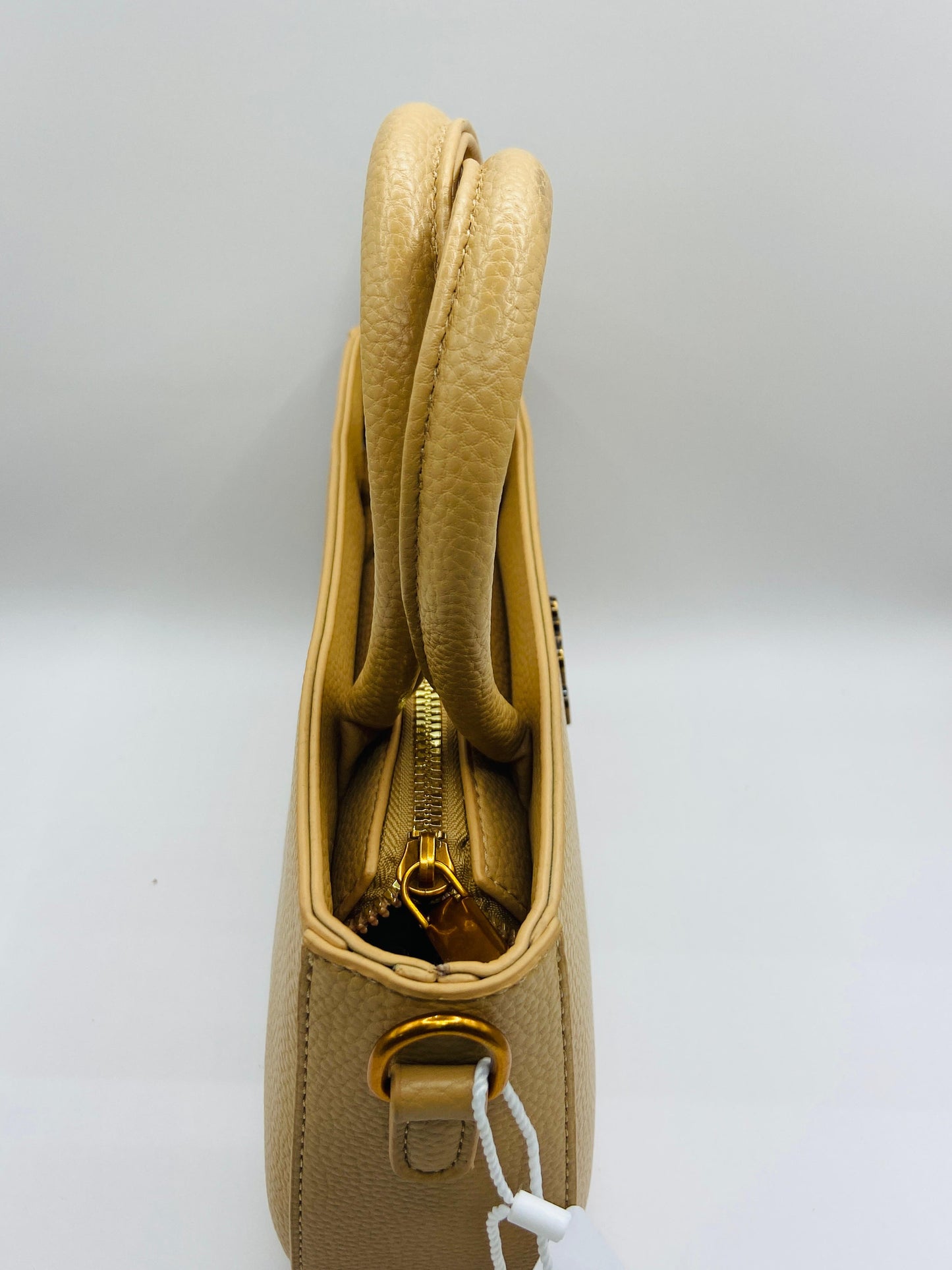 This handbag is a structured, genuine leather tote-style bag designed for modern women who value both elegance and functionality.