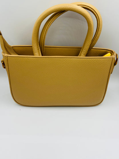This handbag is a structured, genuine leather tote-style bag designed for modern women who value both elegance and functionality.