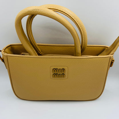 This handbag is a structured, genuine leather tote-style bag designed for modern women who value both elegance and functionality.