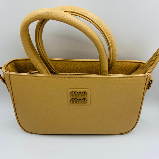 This handbag is a structured, genuine leather tote-style bag designed for modern women who value both elegance and functionality.