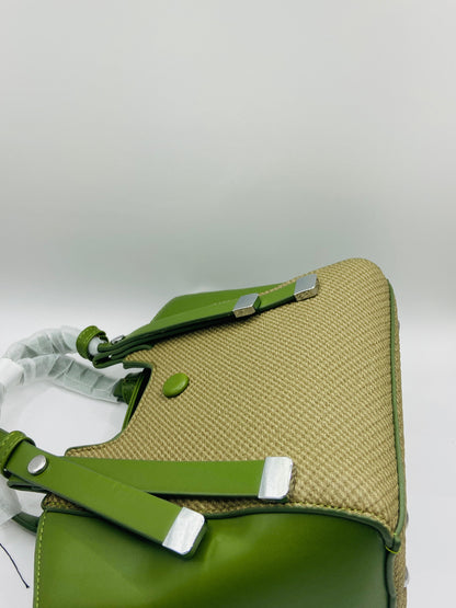 This handbag is a structured, genuine leather tote-style bag designed for modern women who value both elegance and functionality.