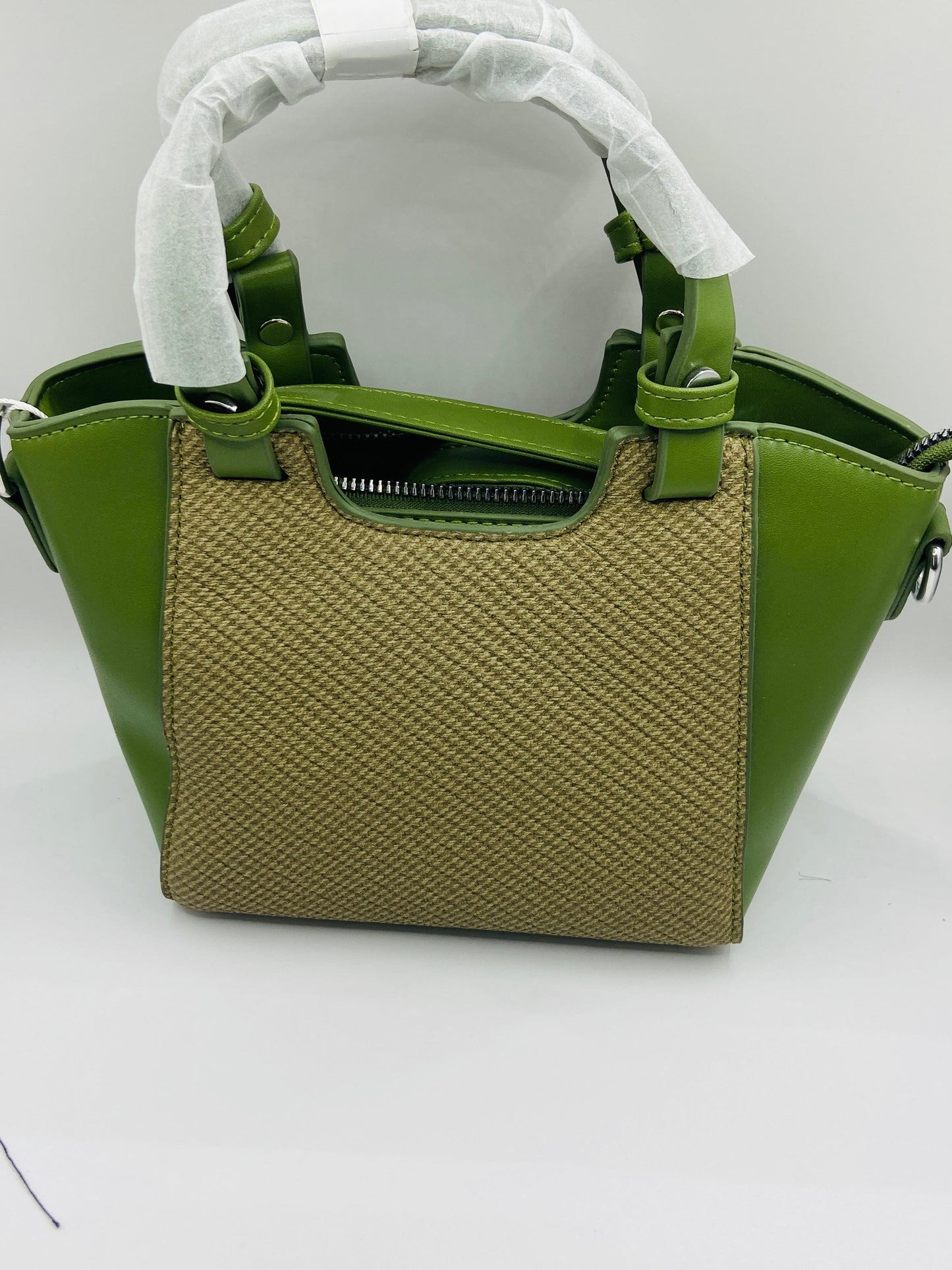 This handbag is a structured, genuine leather tote-style bag designed for modern women who value both elegance and functionality.