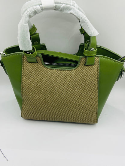 This handbag is a structured, genuine leather tote-style bag designed for modern women who value both elegance and functionality.