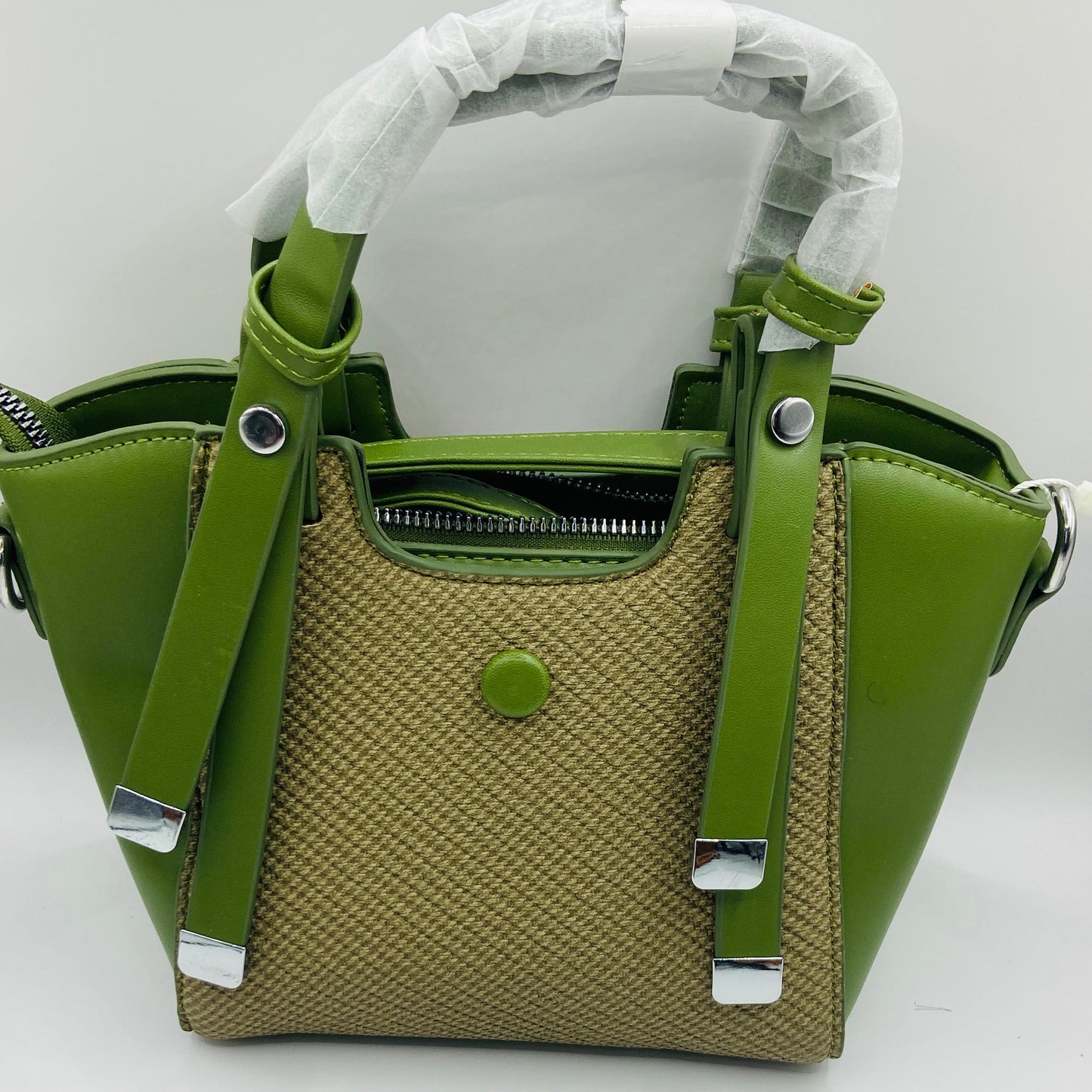 This handbag is a structured, genuine leather tote-style bag designed for modern women who value both elegance and functionality.