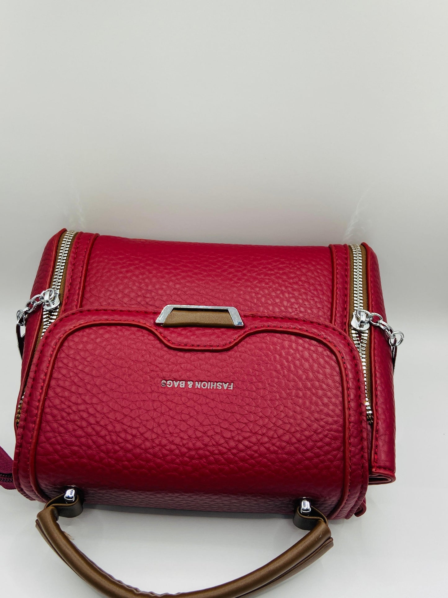 This handbag is a structured, genuine leather tote-style bag designed for modern women who value both elegance and functionality.