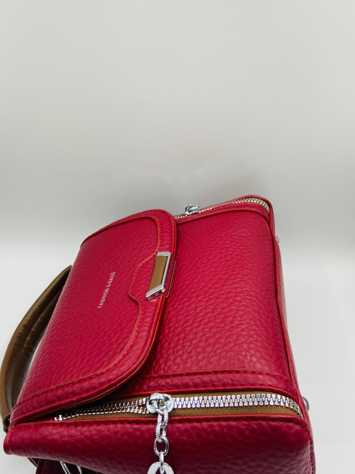 This handbag is a structured, genuine leather tote-style bag designed for modern women who value both elegance and functionality.