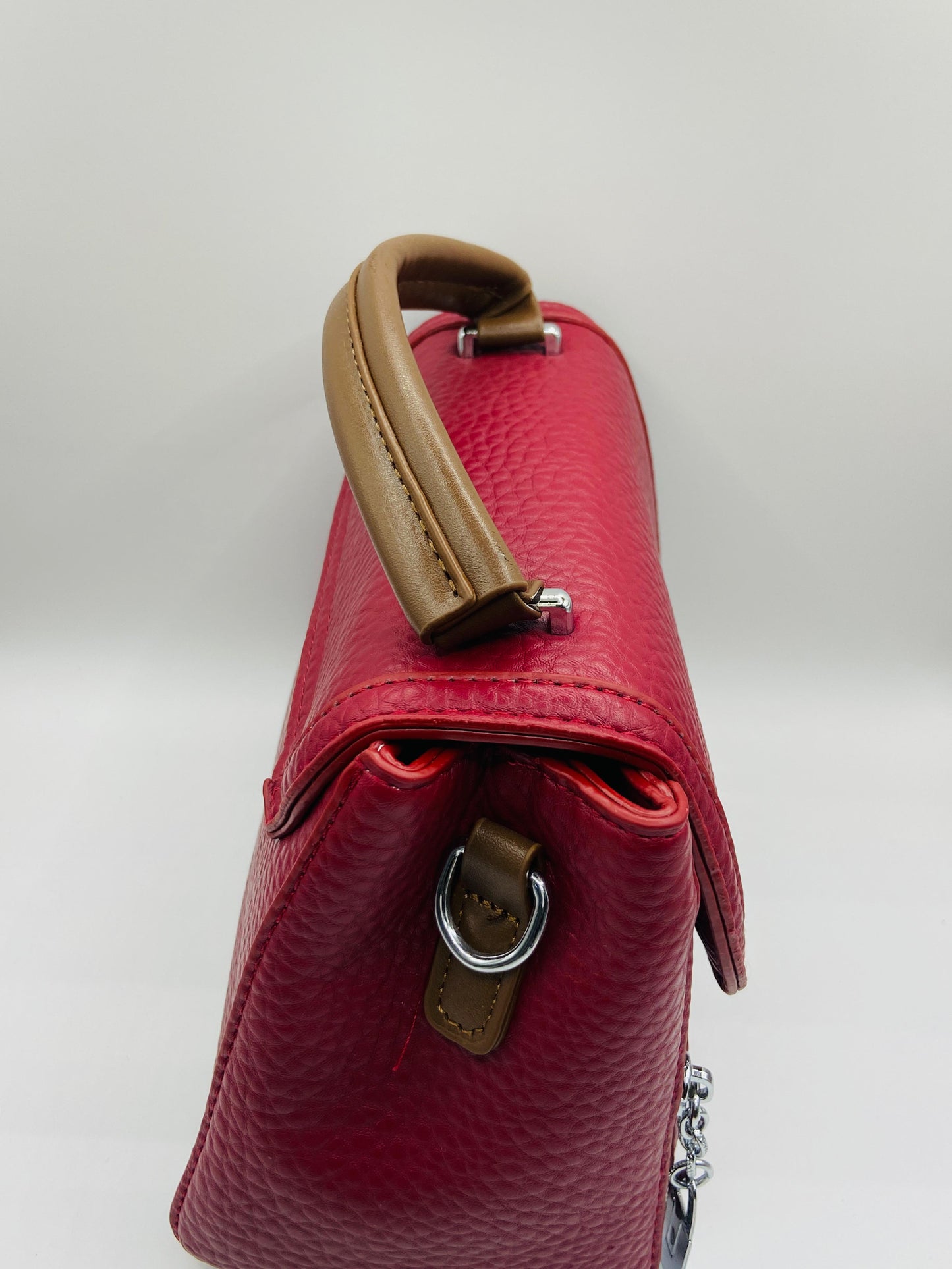 This handbag is a structured, genuine leather tote-style bag designed for modern women who value both elegance and functionality.