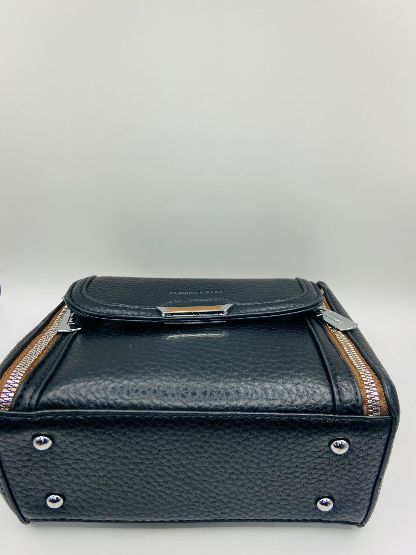 This handbag is a structured, genuine leather tote-style bag designed for modern women who value both elegance and functionality.