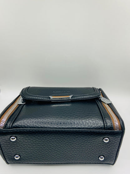 This handbag is a structured, genuine leather tote-style bag designed for modern women who value both elegance and functionality.