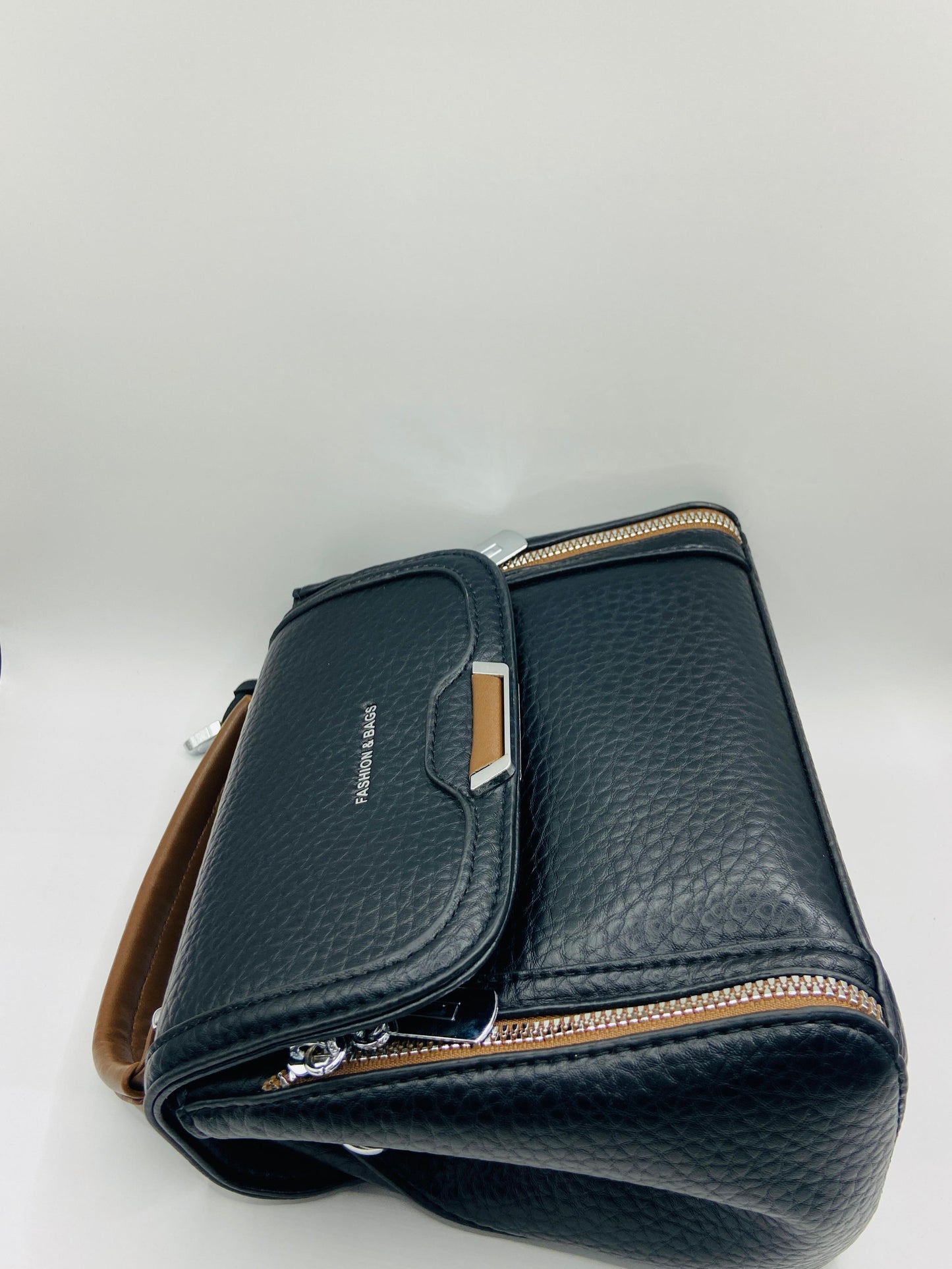 This handbag is a structured, genuine leather tote-style bag designed for modern women who value both elegance and functionality.