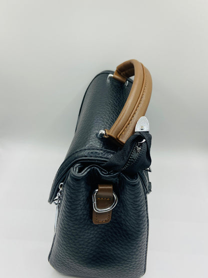 This handbag is a structured, genuine leather tote-style bag designed for modern women who value both elegance and functionality.