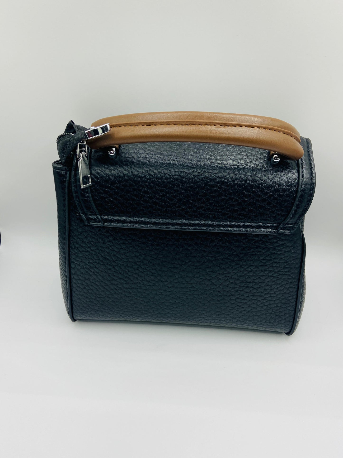This handbag is a structured, genuine leather tote-style bag designed for modern women who value both elegance and functionality.