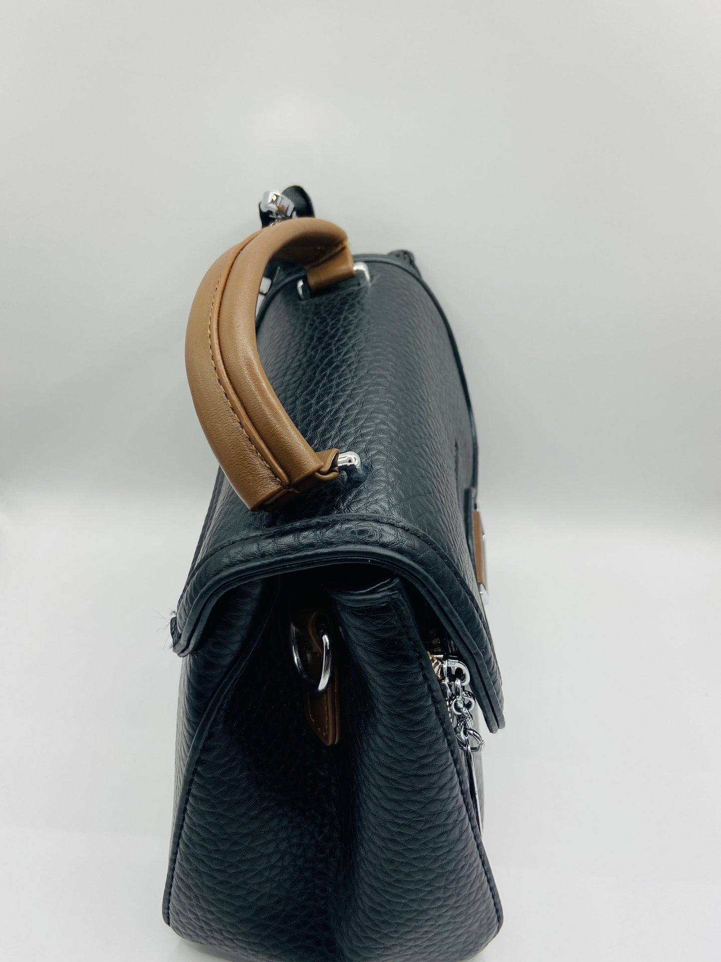 This handbag is a structured, genuine leather tote-style bag designed for modern women who value both elegance and functionality.