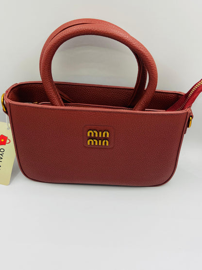 This handbag is a structured, genuine leather tote-style bag designed for modern women who value both elegance and functionality.