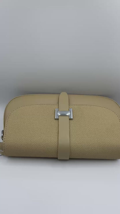 This handbag is a structured, genuine leather tote-style bag designed for modern women who value both elegance and functionality.