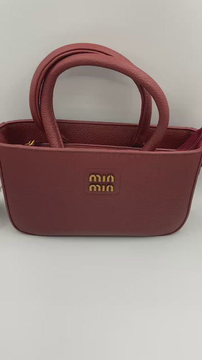 This handbag is a structured, genuine leather tote-style bag designed for modern women who value both elegance and functionality.